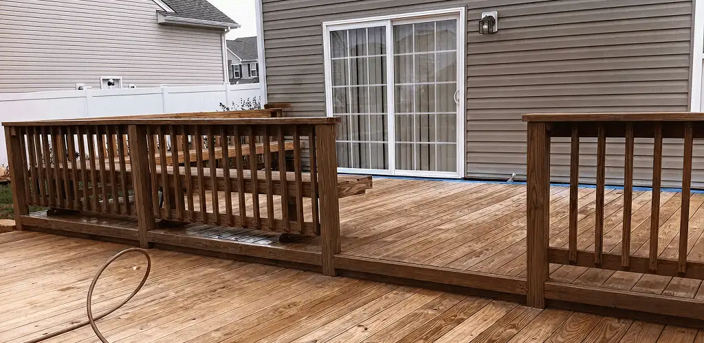Deck sealing service protecting a backyard wood deck and railings in Aurora, IL