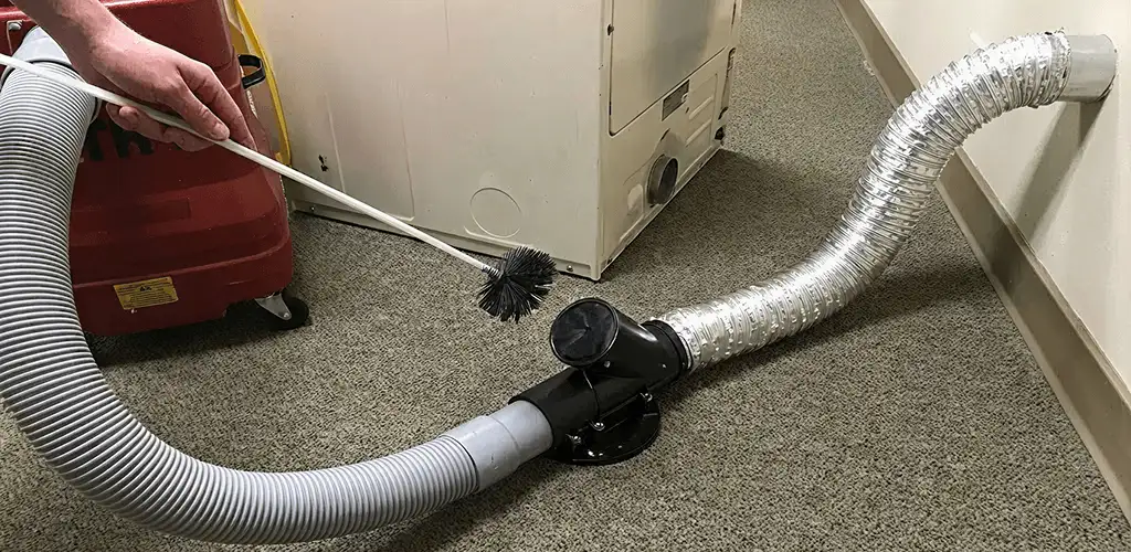 Dryer vent cleaning service removing lint from a dryer duct connection in Aurora, IL