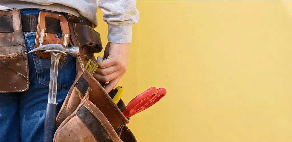 Handyman with tool belt ready for home repairs and maintenance in Aurora, IL