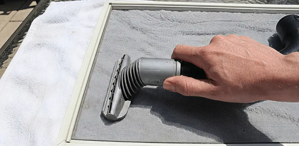 Window screen repair cleaning and fixing a damaged screen mesh in Aurora, IL