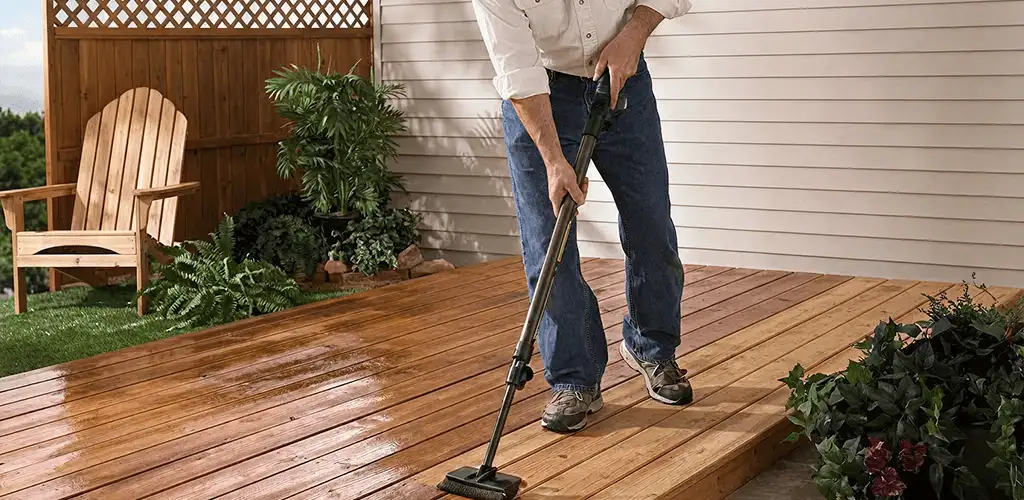 Deck staining service applying stain to a backyard wood deck in Aurora, IL